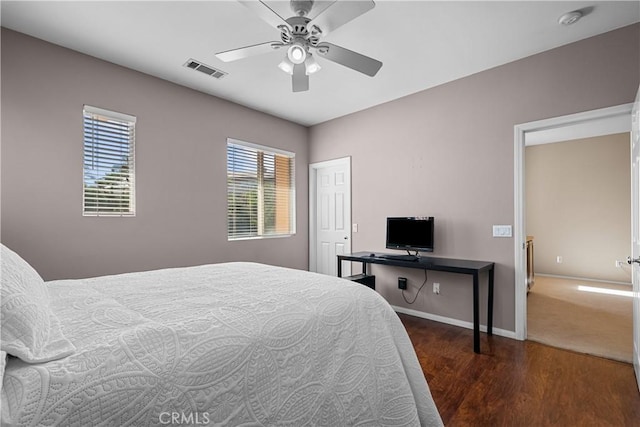 bedroom with ceiling fan and dark hardwood / wood-style flooring