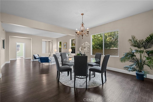 dining space with dark wood-type flooring and a chandelier