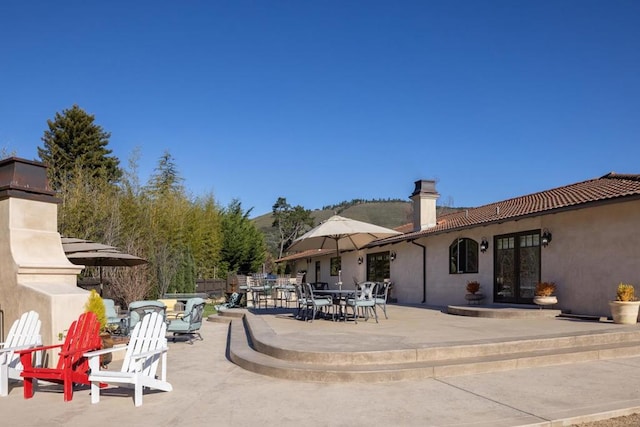 view of patio featuring an outdoor fireplace