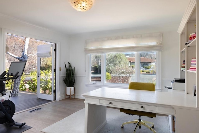 home office with light hardwood / wood-style flooring