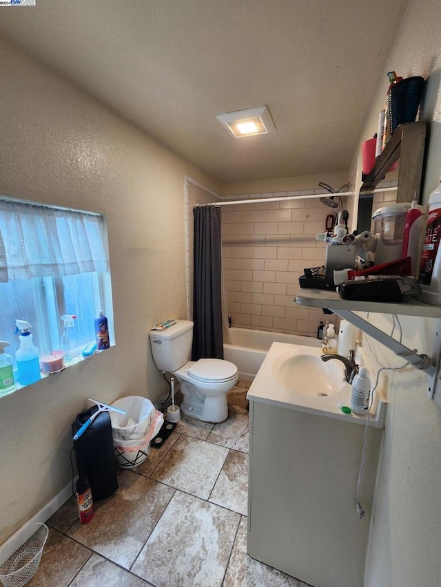 full bathroom featuring shower / bath combination with curtain, vanity, and toilet