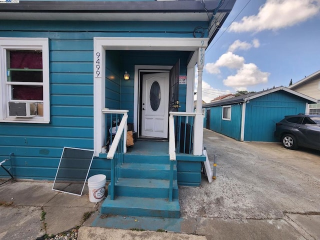 entrance to property featuring cooling unit