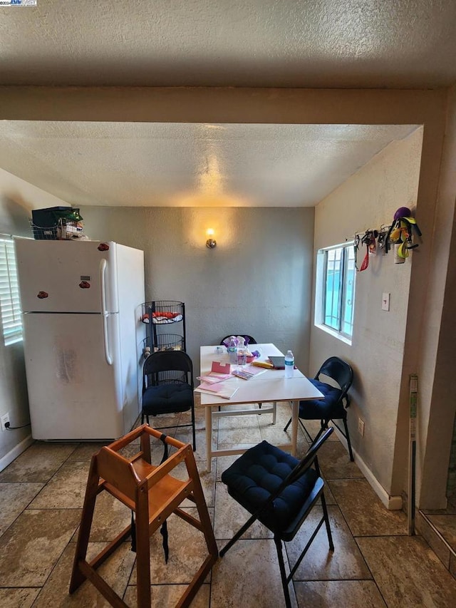 dining space with a textured ceiling