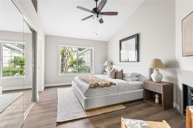 bedroom with ceiling fan, wood-type flooring, a closet, and vaulted ceiling