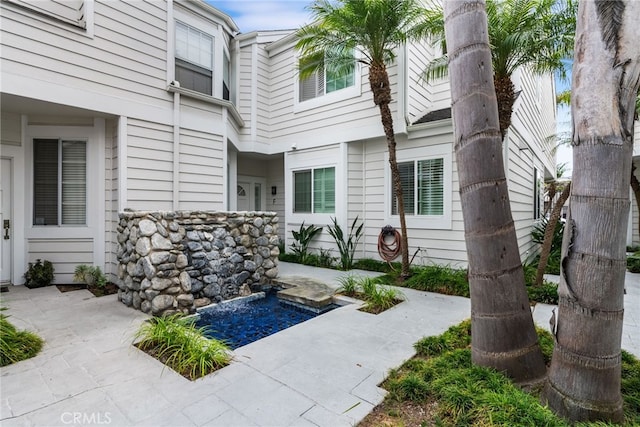 entrance to property featuring a patio