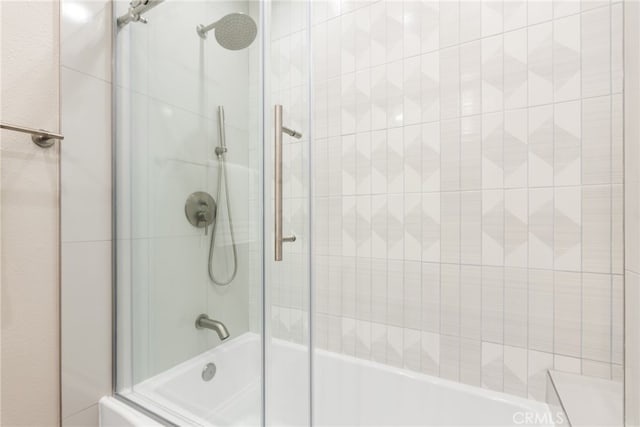 bathroom featuring shower / bath combination with glass door