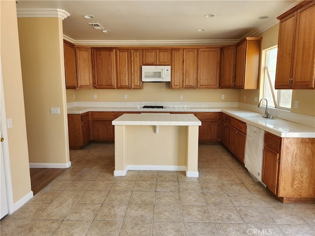 kitchen featuring light tile patterned floors, tile countertops, sink, a center island, and white appliances