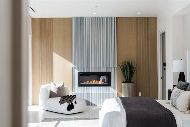 bedroom with a large fireplace and concrete floors