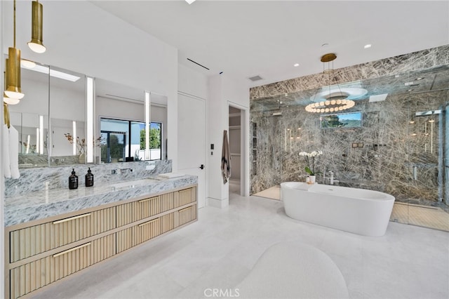 bathroom featuring vanity, tile walls, a chandelier, and separate shower and tub