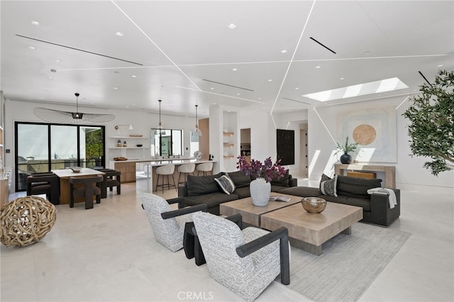 living room featuring a skylight and plenty of natural light