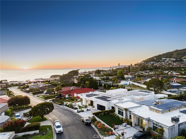 aerial view at dusk with a water view