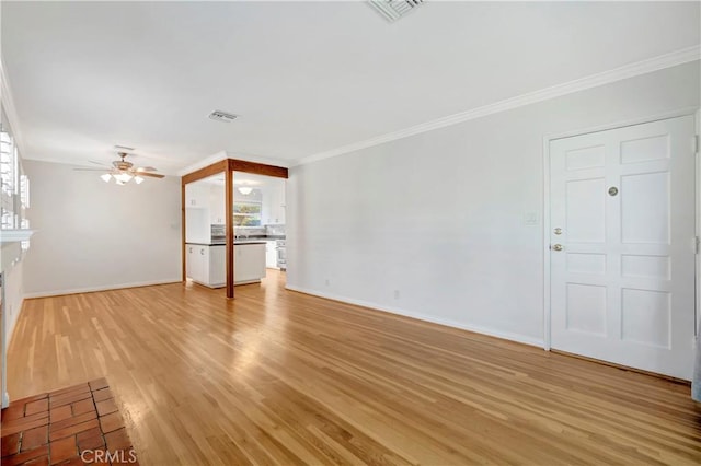 unfurnished living room with light hardwood / wood-style floors, ceiling fan, and crown molding