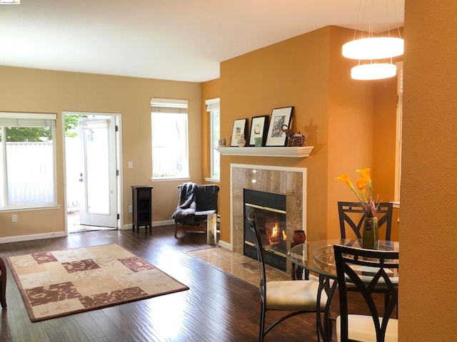 interior space with dark wood-type flooring and a tile fireplace