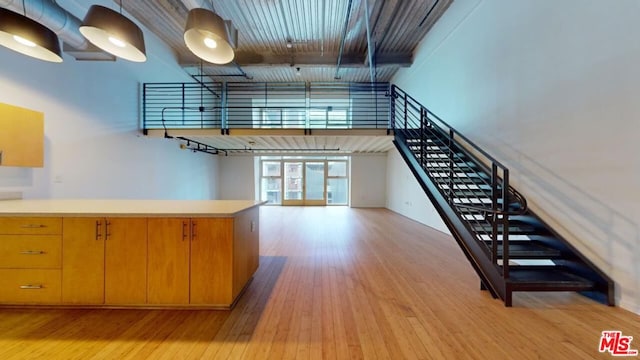 kitchen with a high ceiling and light hardwood / wood-style floors