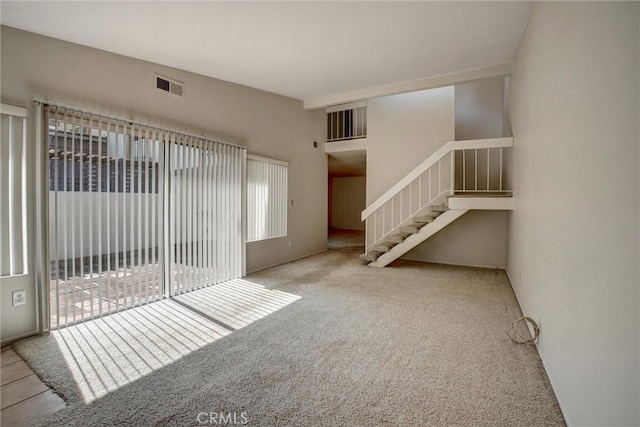 unfurnished living room with light carpet