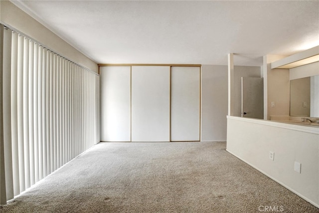 carpeted spare room with sink