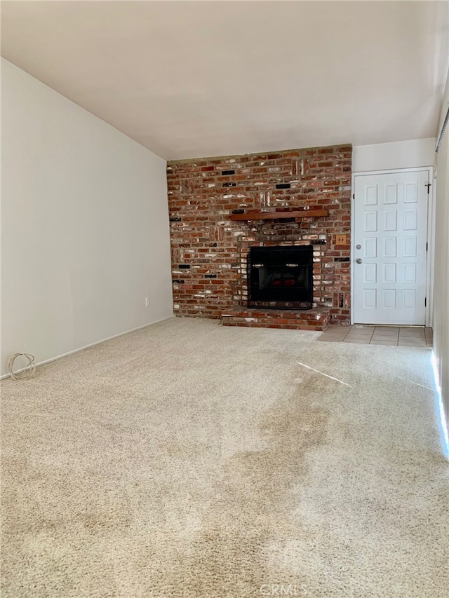 unfurnished living room featuring light colored carpet and a fireplace