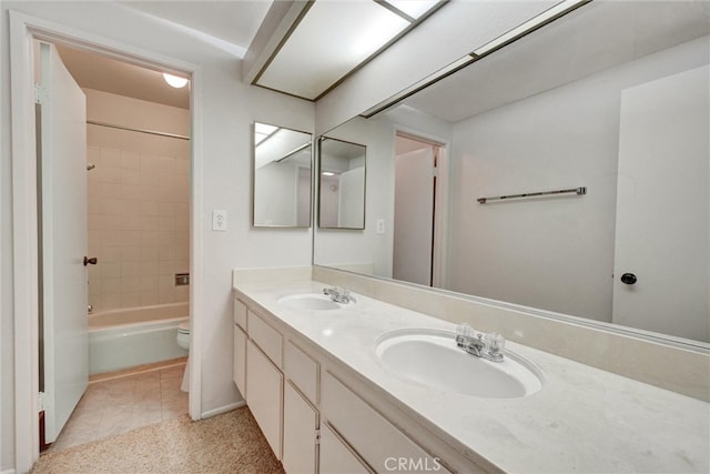 full bathroom with toilet, tiled shower / bath combo, vanity, and tile patterned flooring