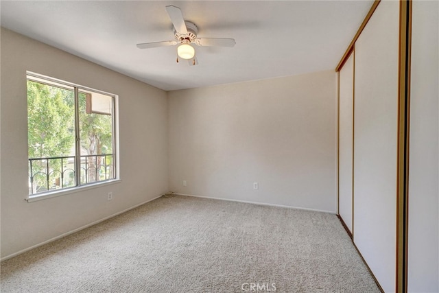 unfurnished room with light colored carpet and ceiling fan