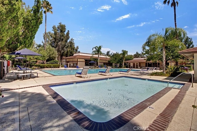 view of swimming pool with a patio