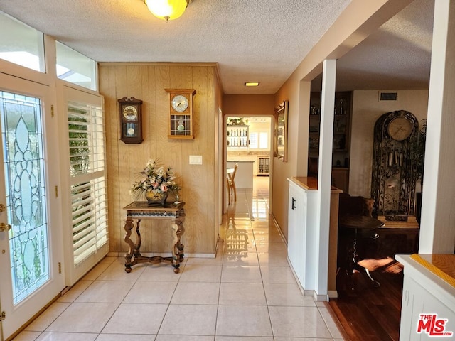 tiled foyer entrance featuring a textured ceiling