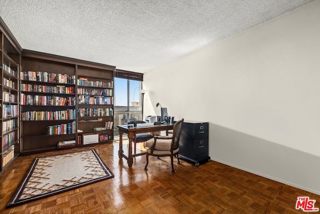 home office with dark parquet floors and a textured ceiling