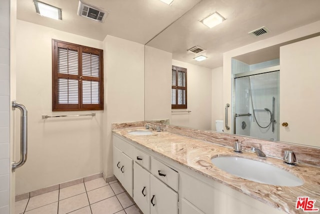 bathroom featuring tile patterned floors, walk in shower, vanity, and toilet