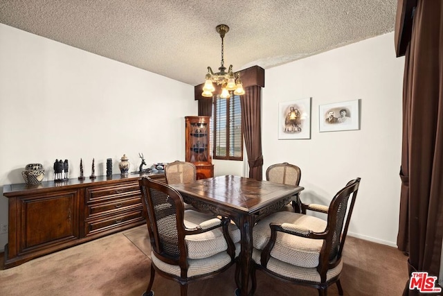 dining area with a chandelier, a textured ceiling, and light colored carpet