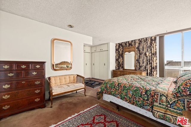 bedroom featuring carpet floors and a textured ceiling