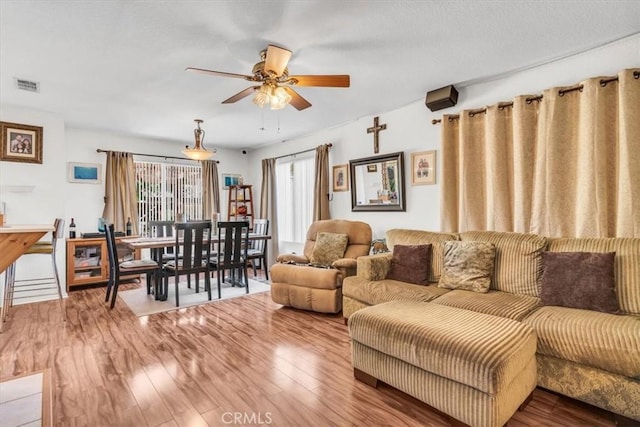 living room with hardwood / wood-style floors and ceiling fan