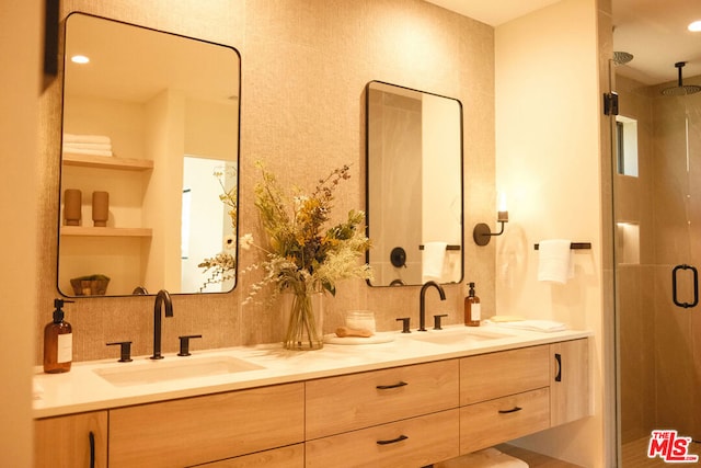 bathroom with vanity and a shower with shower door