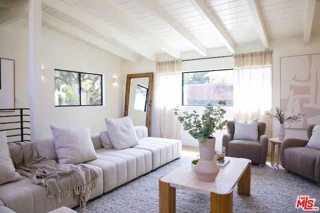 living room with carpet, lofted ceiling with beams, and a healthy amount of sunlight