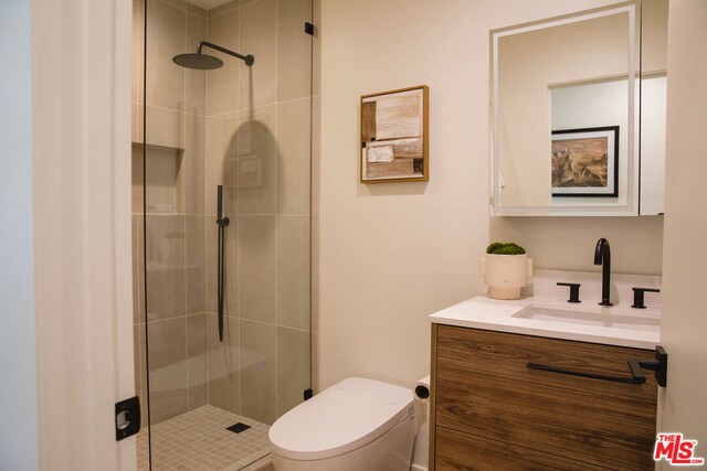 bathroom with walk in shower, vanity, and toilet