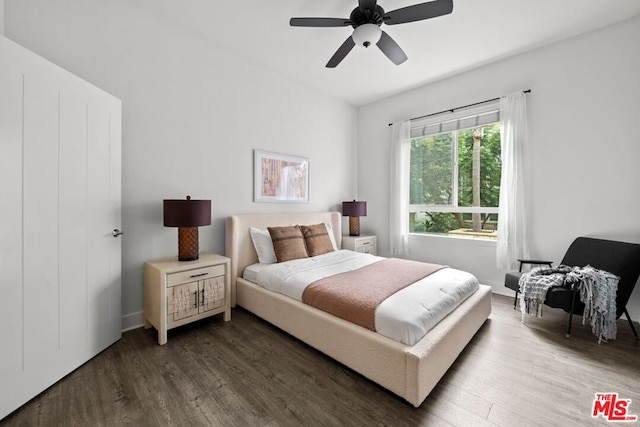 bedroom with ceiling fan and dark wood-type flooring