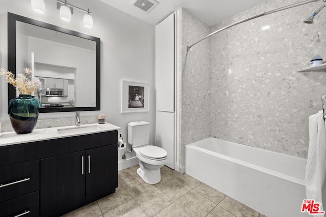 full bathroom with vanity, tiled shower / bath combo, toilet, and tile patterned flooring