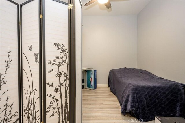 bedroom with light hardwood / wood-style flooring and ceiling fan