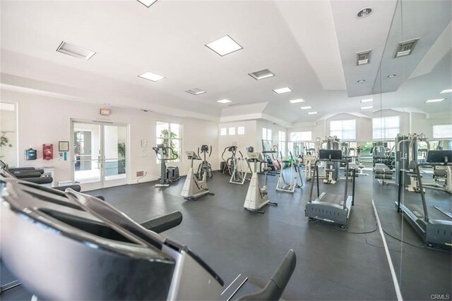 gym with french doors and lofted ceiling