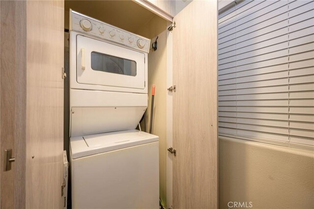 laundry area featuring stacked washer and dryer