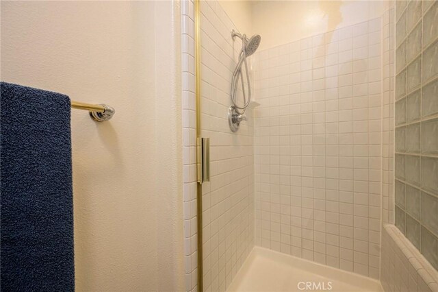 bathroom with a shower with shower door