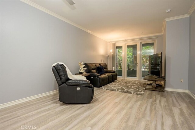 living room featuring crown molding and light wood-type flooring