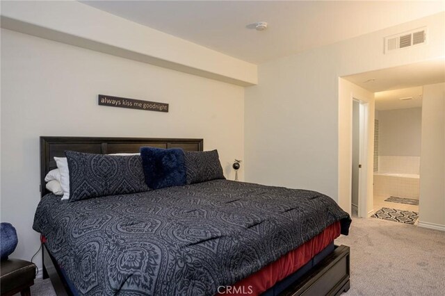 carpeted bedroom with ensuite bathroom