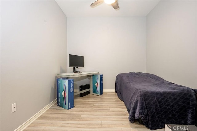 bedroom with light hardwood / wood-style flooring and ceiling fan