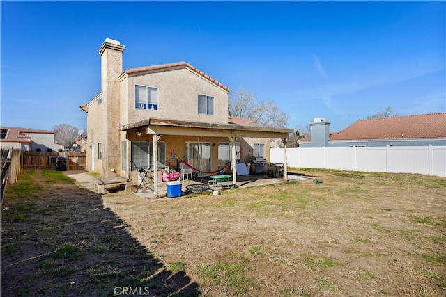 back of house with a yard and a patio area