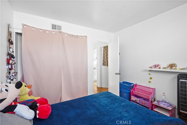 bedroom featuring heating unit