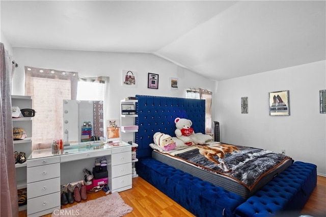 bedroom with light hardwood / wood-style flooring and vaulted ceiling