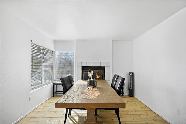 dining area featuring light hardwood / wood-style floors and a fireplace