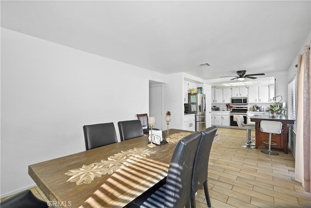 dining space featuring light hardwood / wood-style floors and ceiling fan