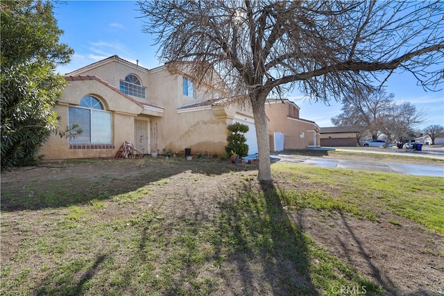 view of front of house with a front yard and a garage