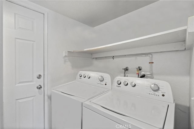 clothes washing area featuring independent washer and dryer