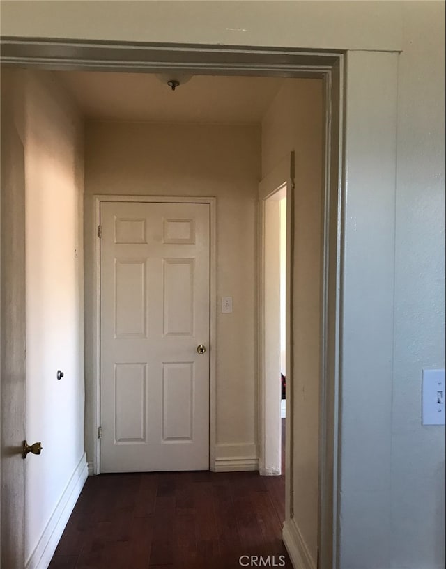 corridor with dark hardwood / wood-style floors